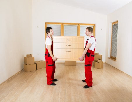 Removal team transporting household furniture through a local street
