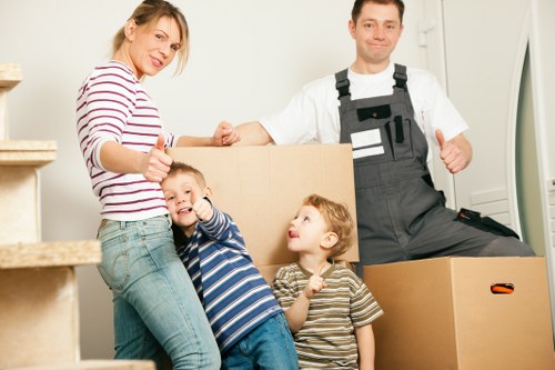 Trained moving staff using PPE while carrying furniture safely
